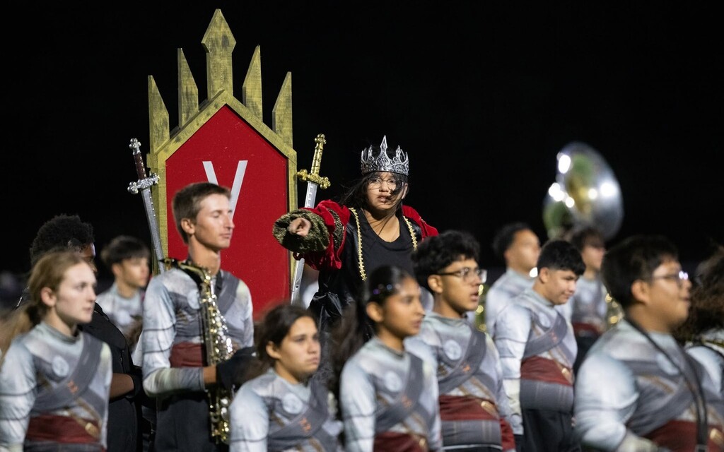 El Campo Ricebird Marching Band members in uniform with drum majors on podiums.