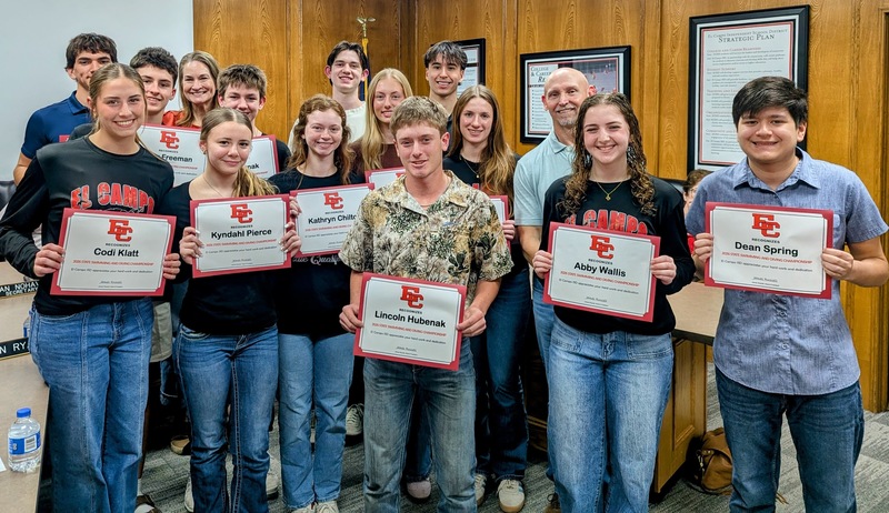 swim and dive team with coaches at board meeting