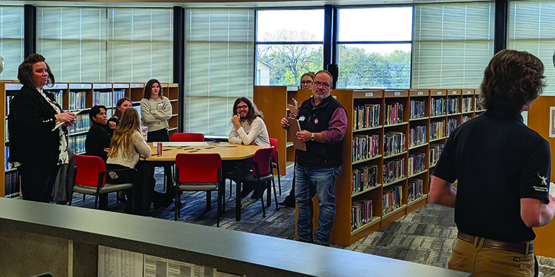 Students working on consensus building activity in the EHS library