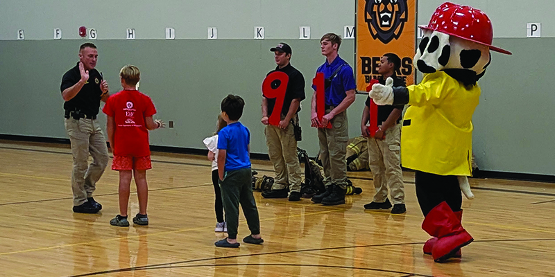 students help Sparky with the emergency number 911