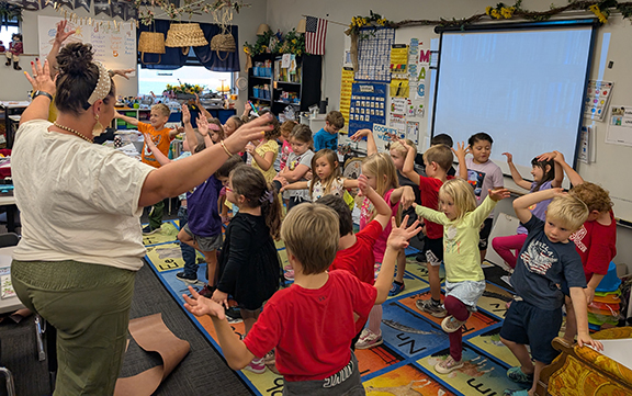 Grandview kindergarten reads Tap the Magic Tree