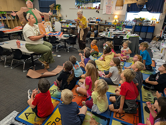 Grandview kindergarten reads Tap the Magic Tree