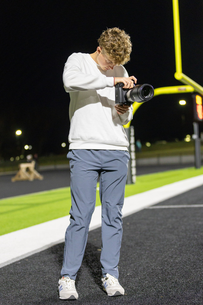 boy taking pictures at football