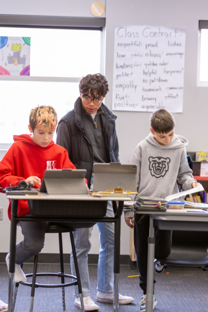 high school student spending time in elementary classroom