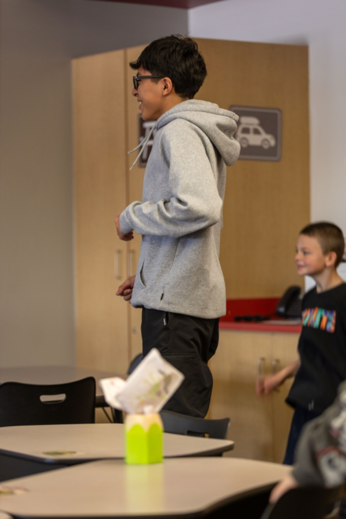 high school student spending time in elementary classroom