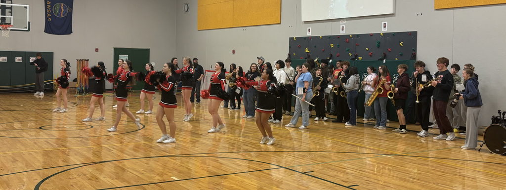 EHS cheer and band performing songs in a gym