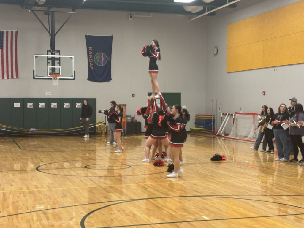 EHS cheer and band performing songs in a gym