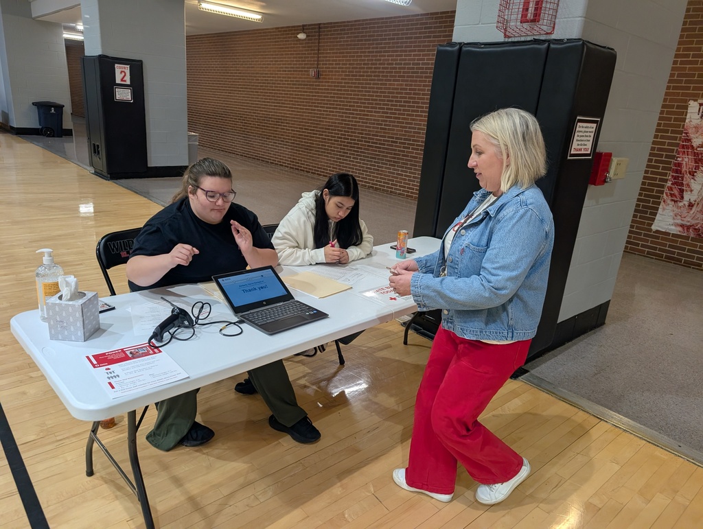 students check in a staff member for a blood donation