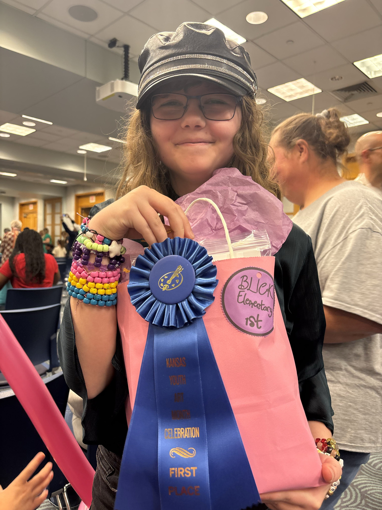 Katharine holds her first place ribbon and gift bag