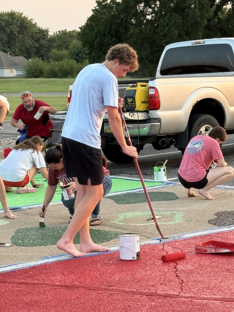 seniors painting parking spots