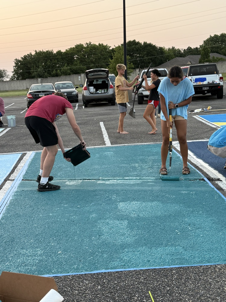 seniors painting parking spots