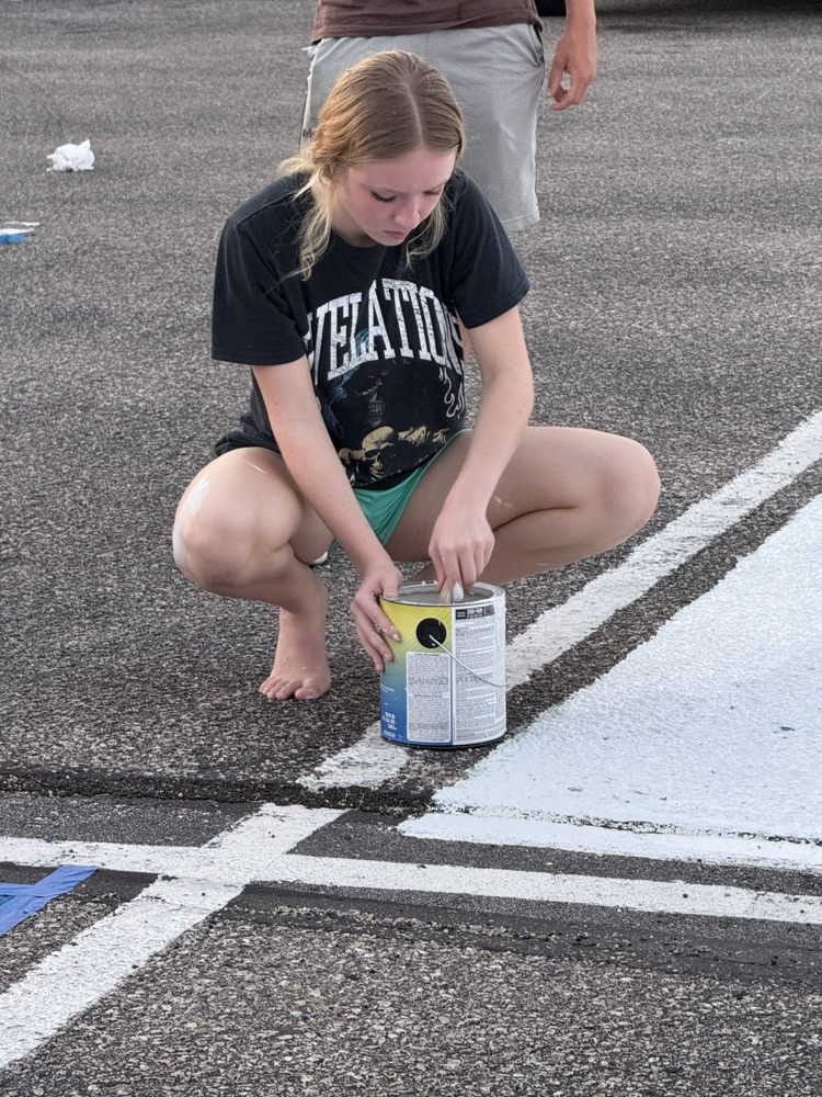 seniors painting parking spots