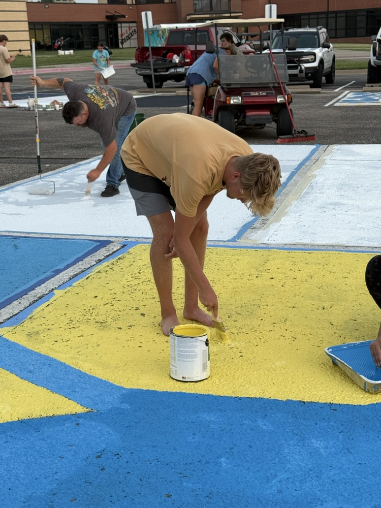 seniors painting parking spots
