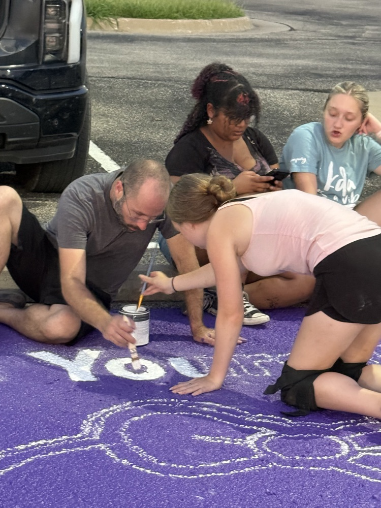 seniors painting parking spots