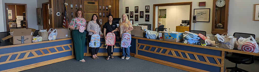 Wendy McAdoo, Suniva Das, and Sasha Fowler with HF Sinclair delivering school supplies to the District Office