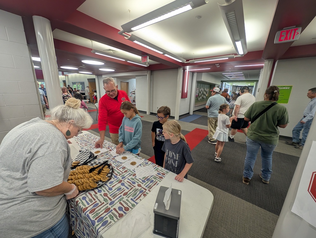 students and grandparents enjoy cookies as part of the Grandparent Day celebration