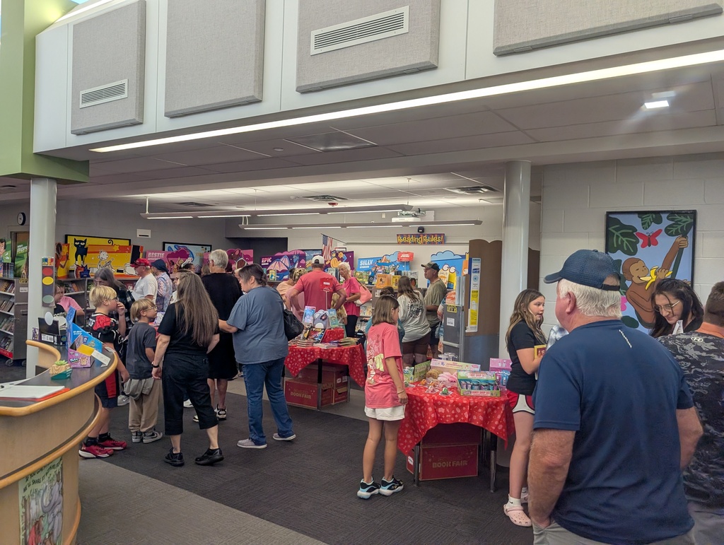 Grandparents and students browse the book fair in the libary at Grandview