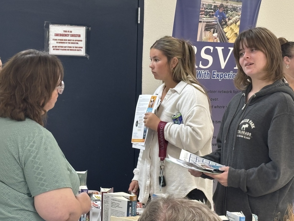 students talking to volunteers