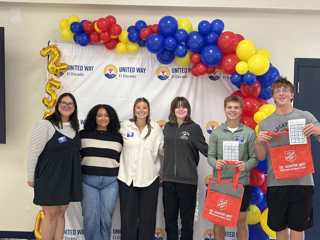 Students pose in front of the United Way backdrop