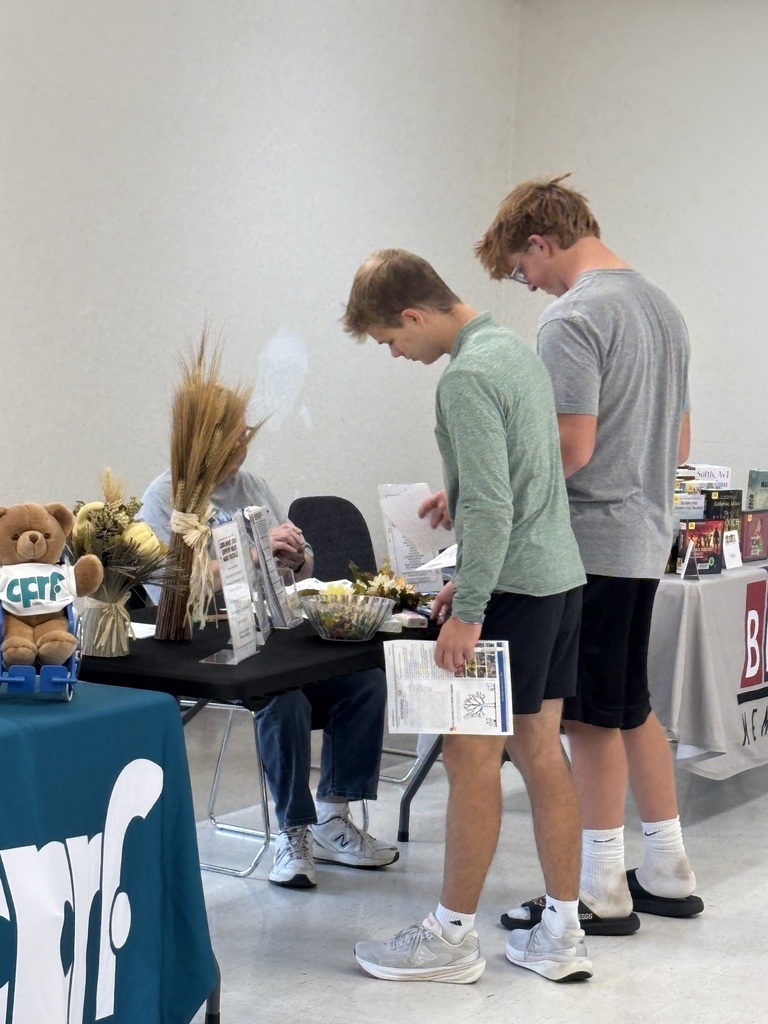 students look at items on a table
