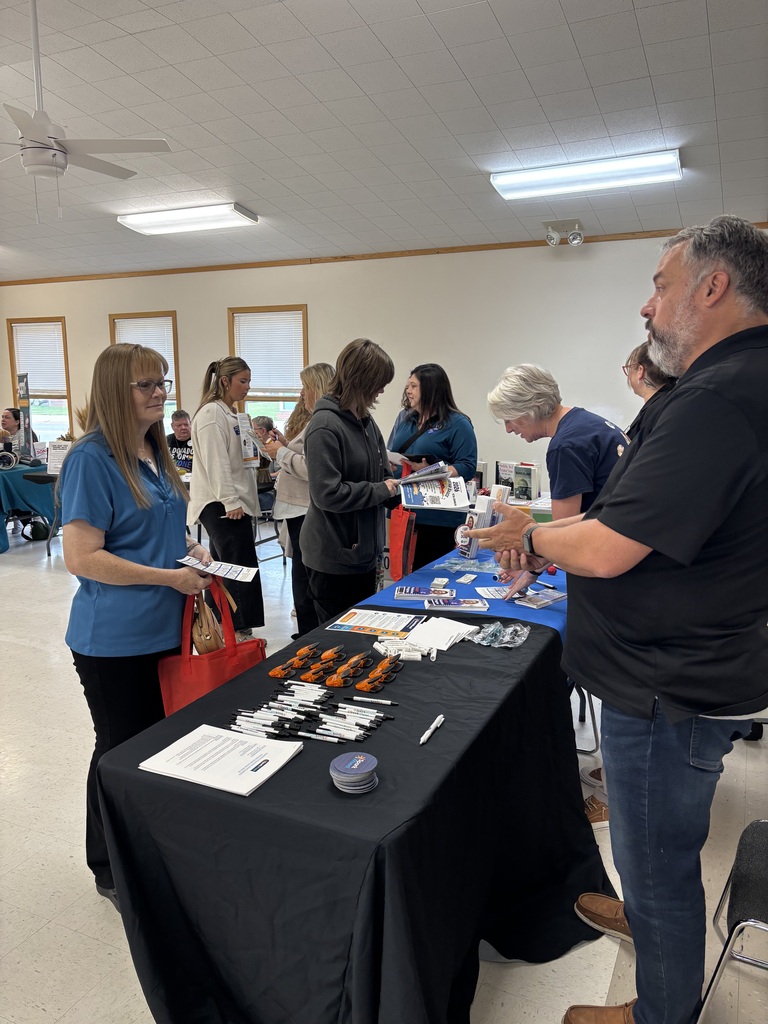 students speak to community group volunteers and staff