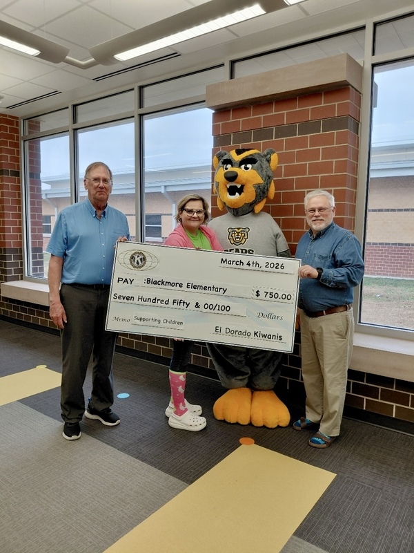 Kiwanis members present Blackmore Principal Anita Arnold with a check for the school for $750