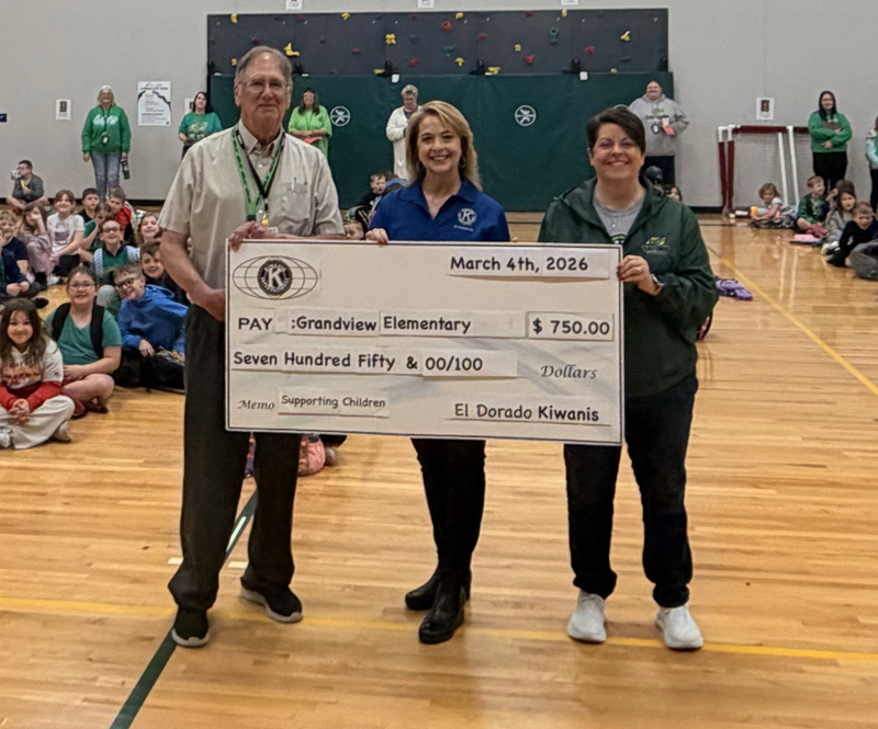 Kiwanis members presentGrandview Principal Midge Simmons with a check for the school for $750