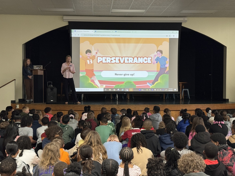 principal talking to a crowd of students about perseverance
