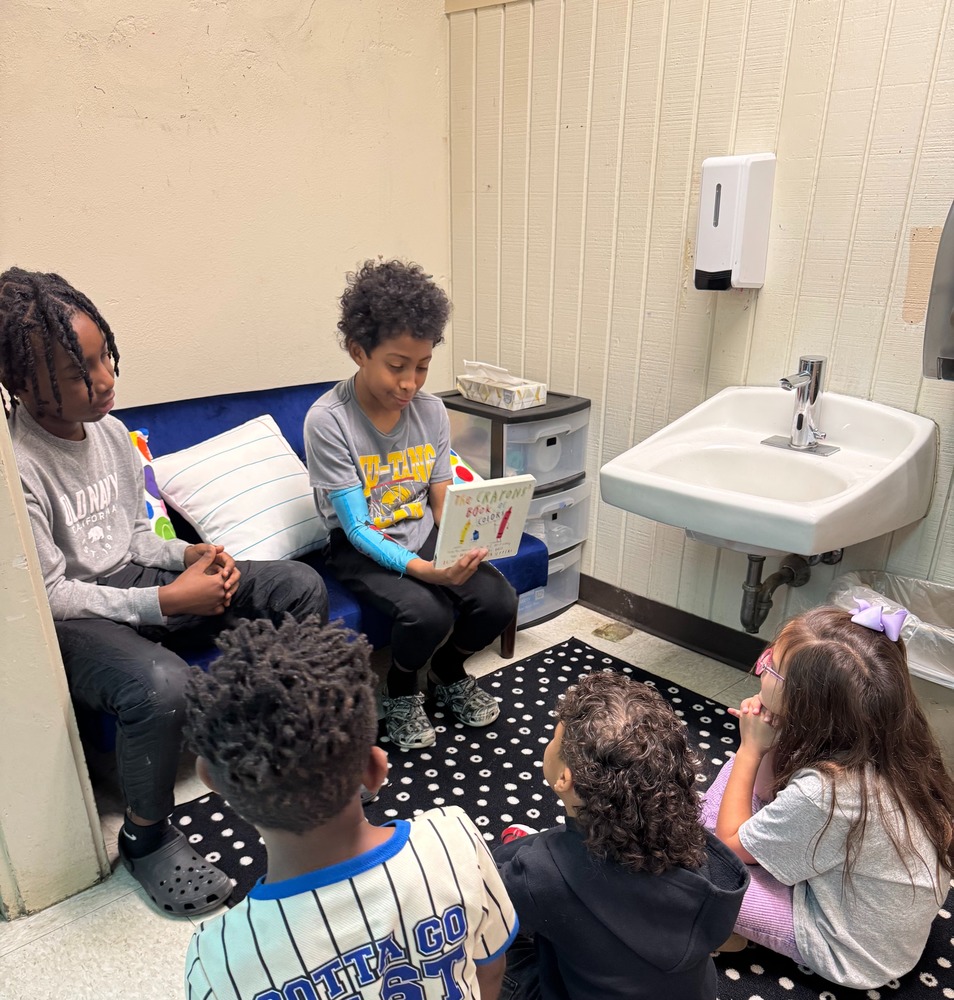 Boys reading to kinders