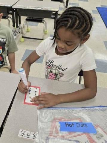 student working on recognizing letters