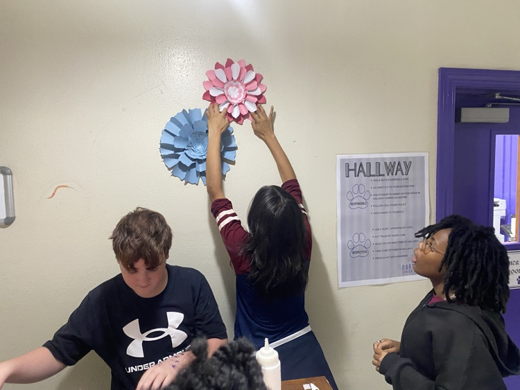 group 1 with flowers on wall