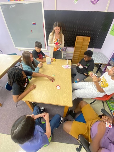 Ms. Boyd playing Uno with a group