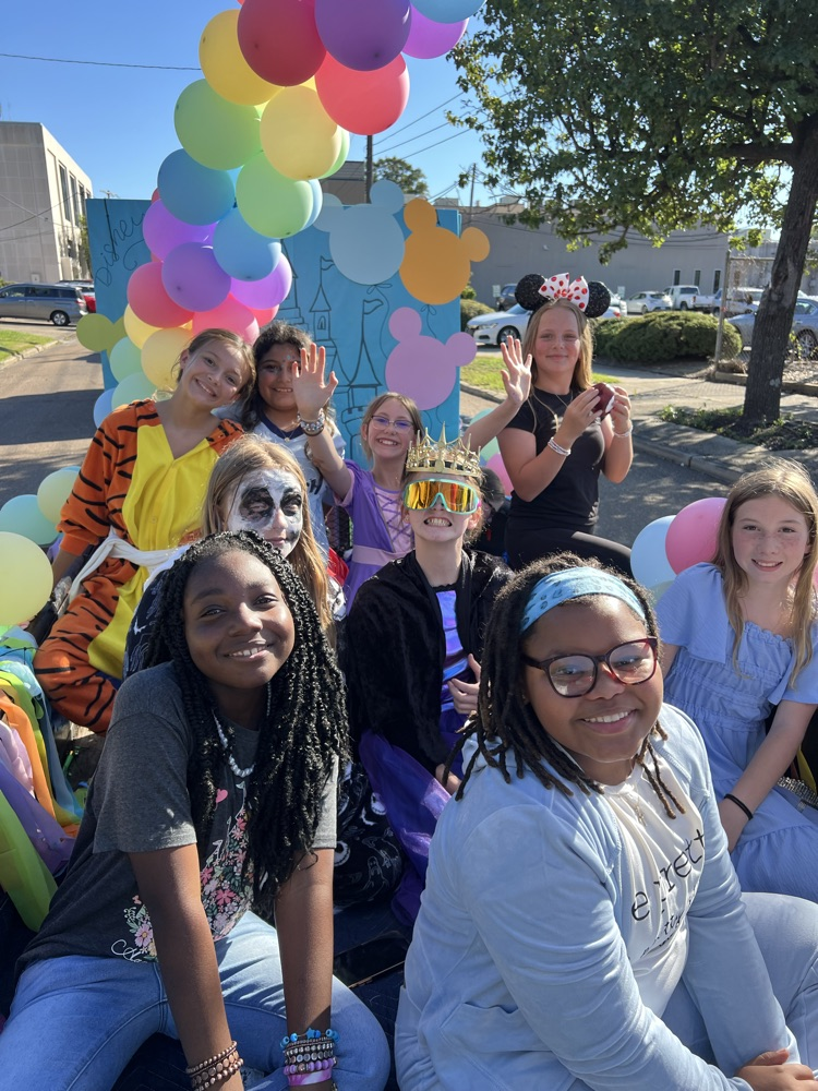 students smiling on the parade float