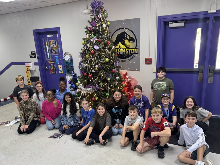 students in front of the Christmas tree