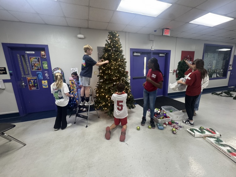 students decorating Christmas tree