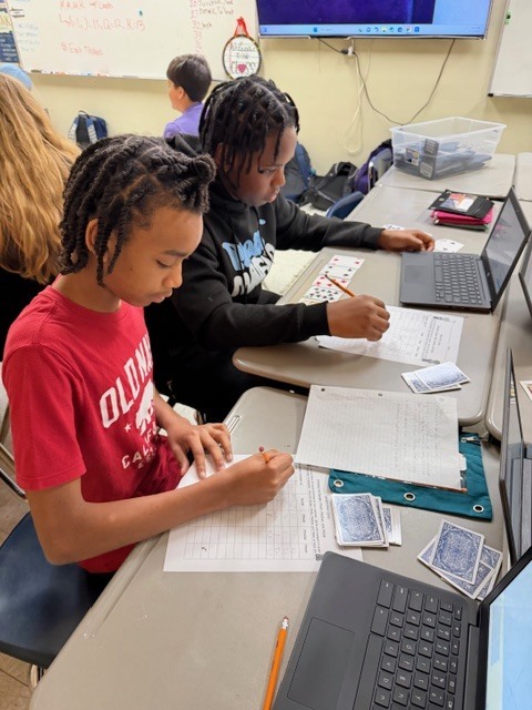 Students working on math with cards