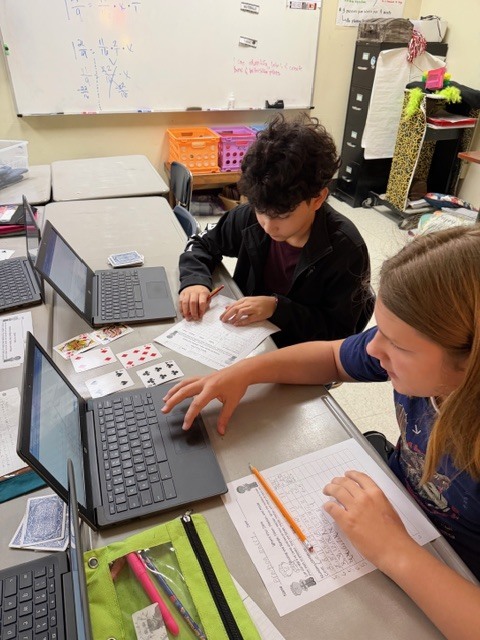 Students working on math with cards