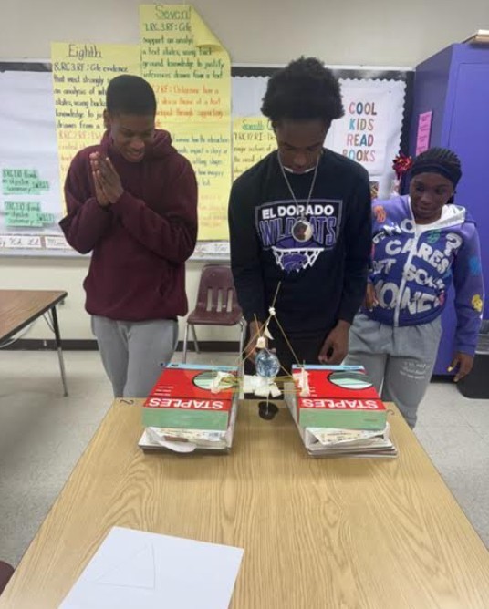 Spaghetti bridge holding small, full water bottle