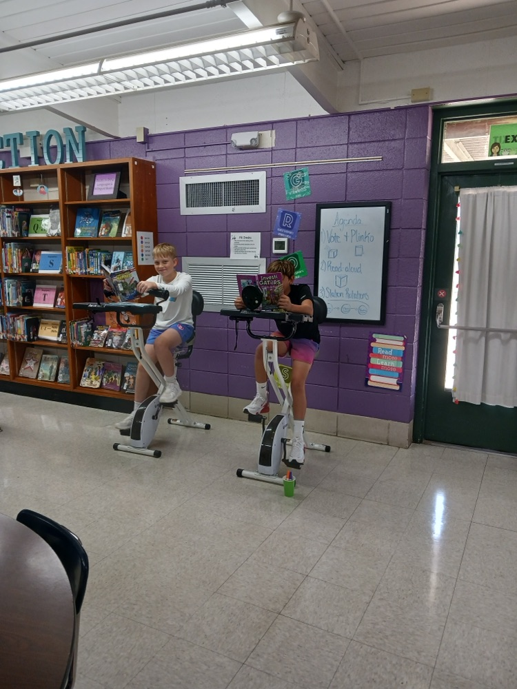 students reading on bikes