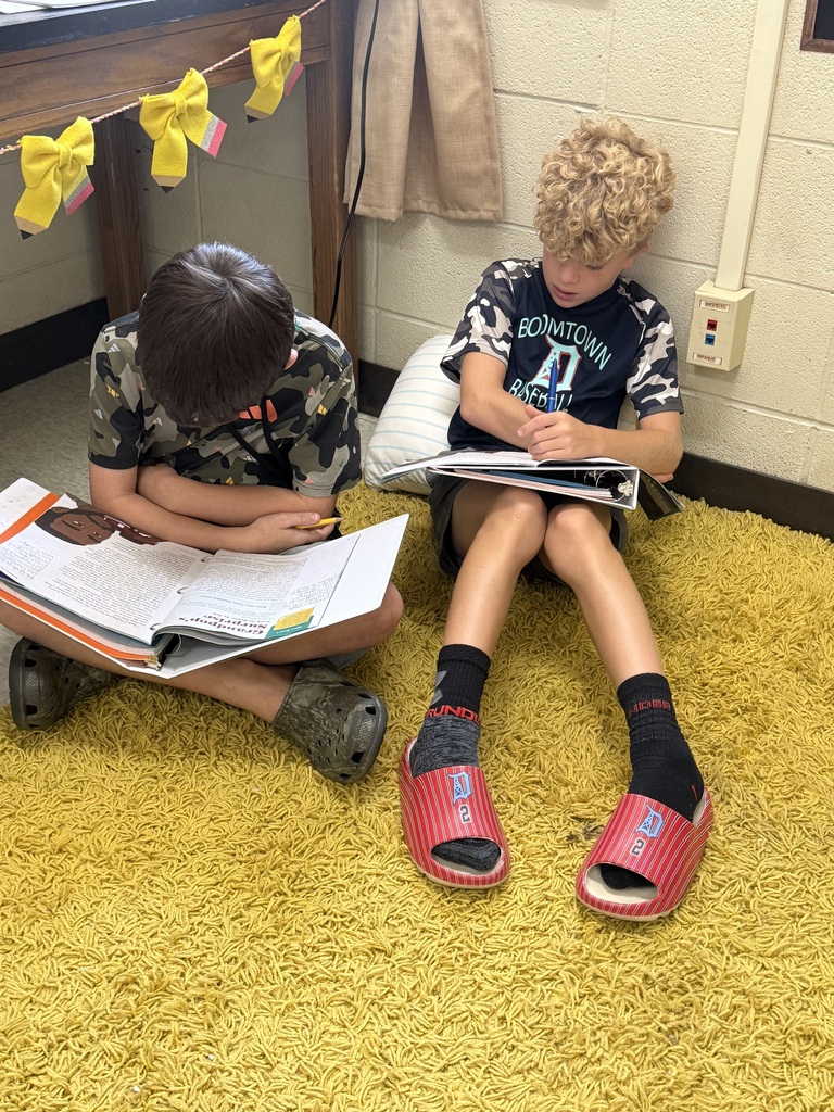 Students reading in different places in the classroom