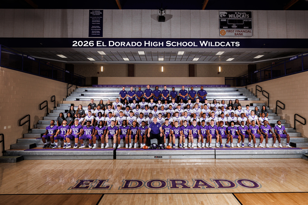 2026 El Dorado High School Wildcats football team, coaches, and support staff posing together on the gym bleachers. Players wear purple and white uniforms, with coaches standing behind them. “2026 El Dorado High School Wildcats” appears above the group, and “El Dorado” is visible on the gym floor.