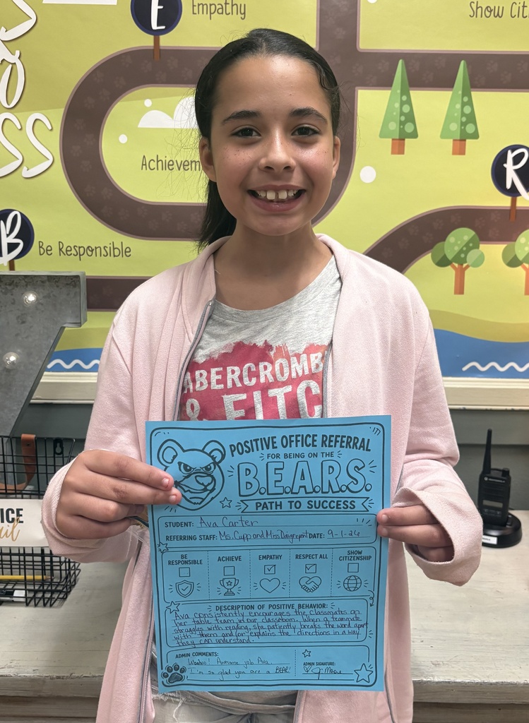 Ava Carter standing with a positive office referral