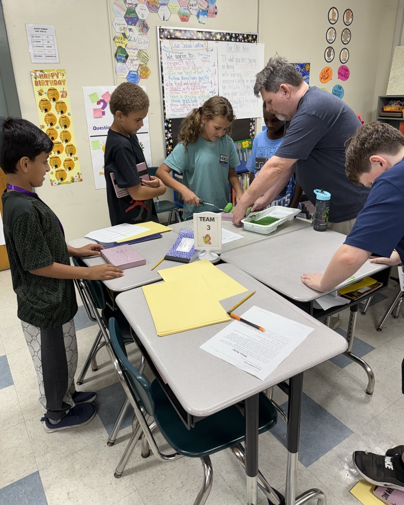 students with a paint roller putting paint on foam for prints