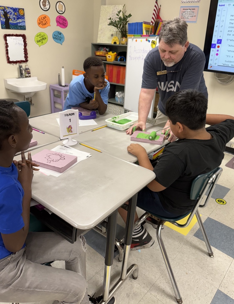 students painting pieces of foam on a desk