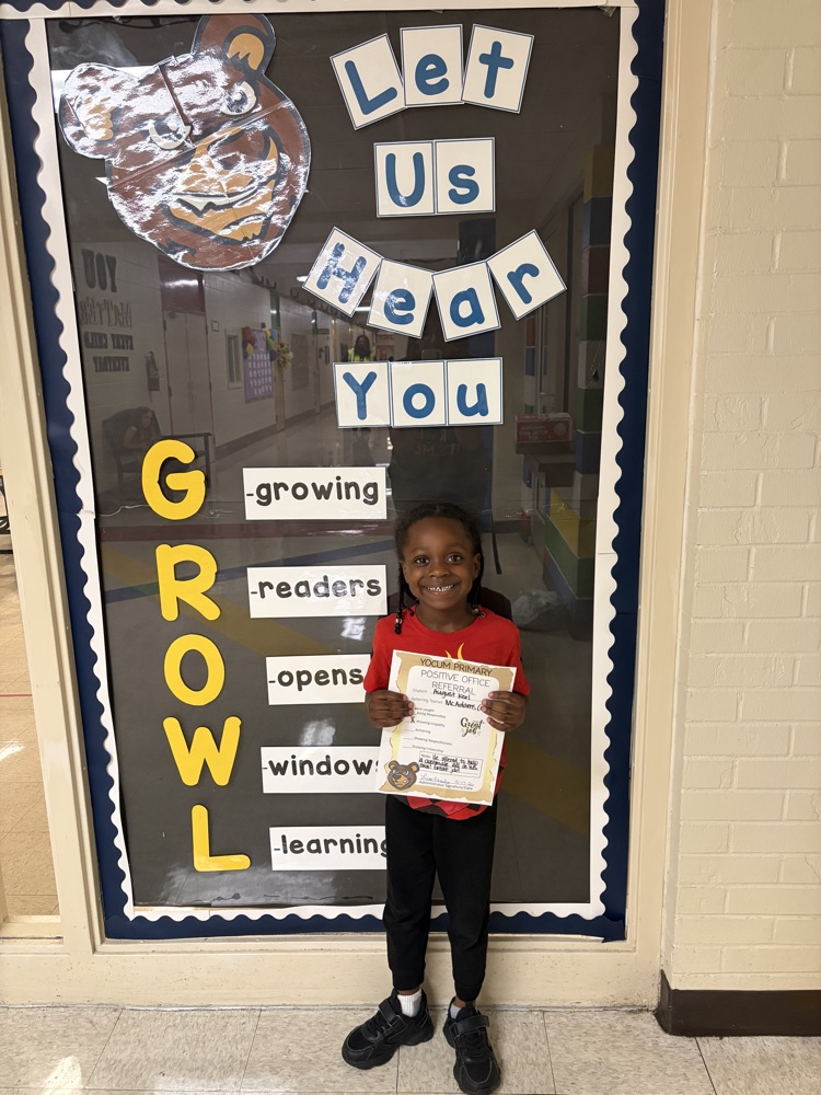 student holding a positive office referral paper