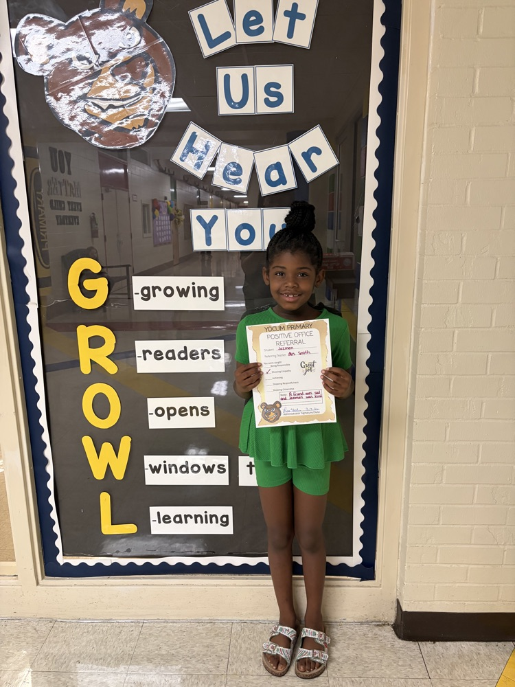 student holding a positive office referral paper