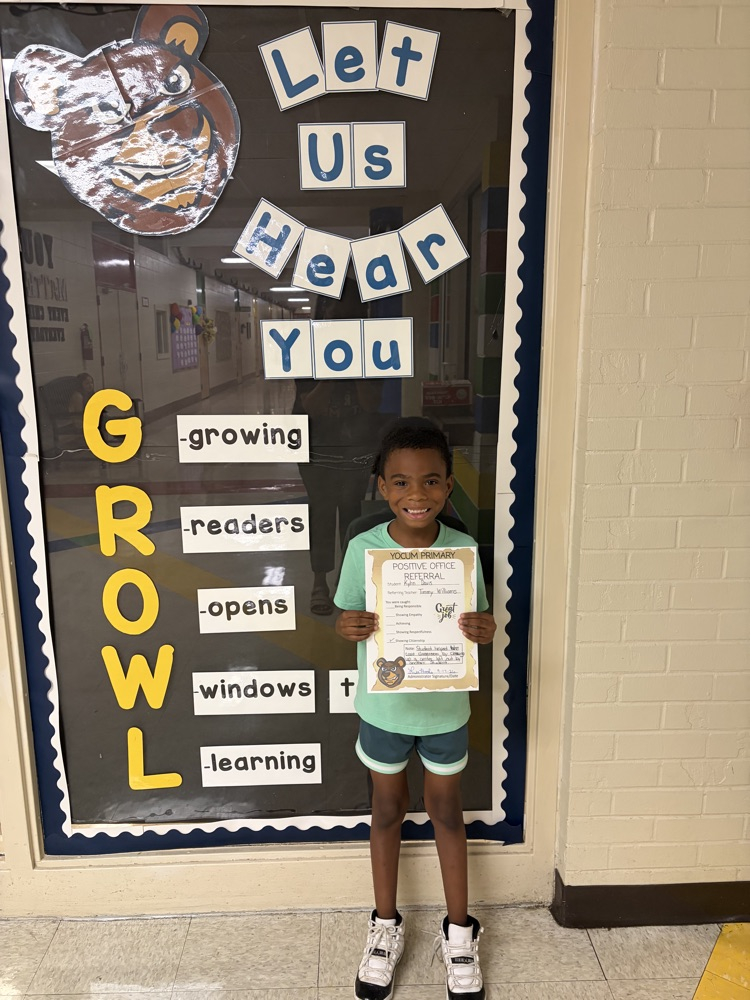 student holding a positive office referral paper