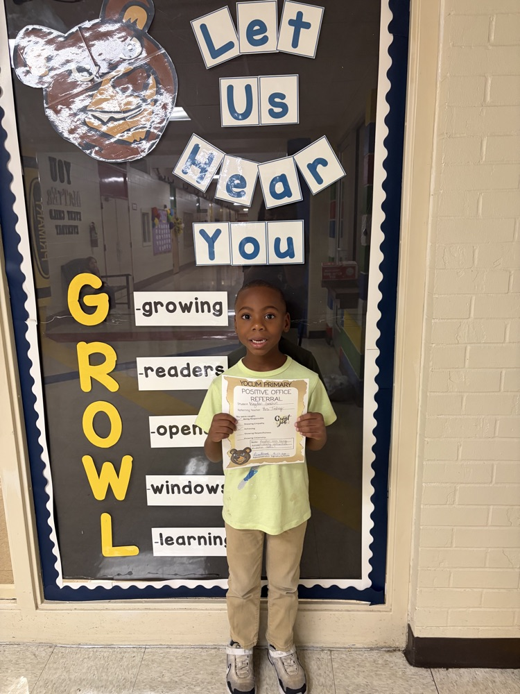 student holding a positive office referral paper