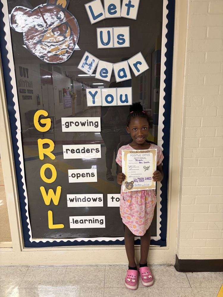 student holding a positive office referral paper