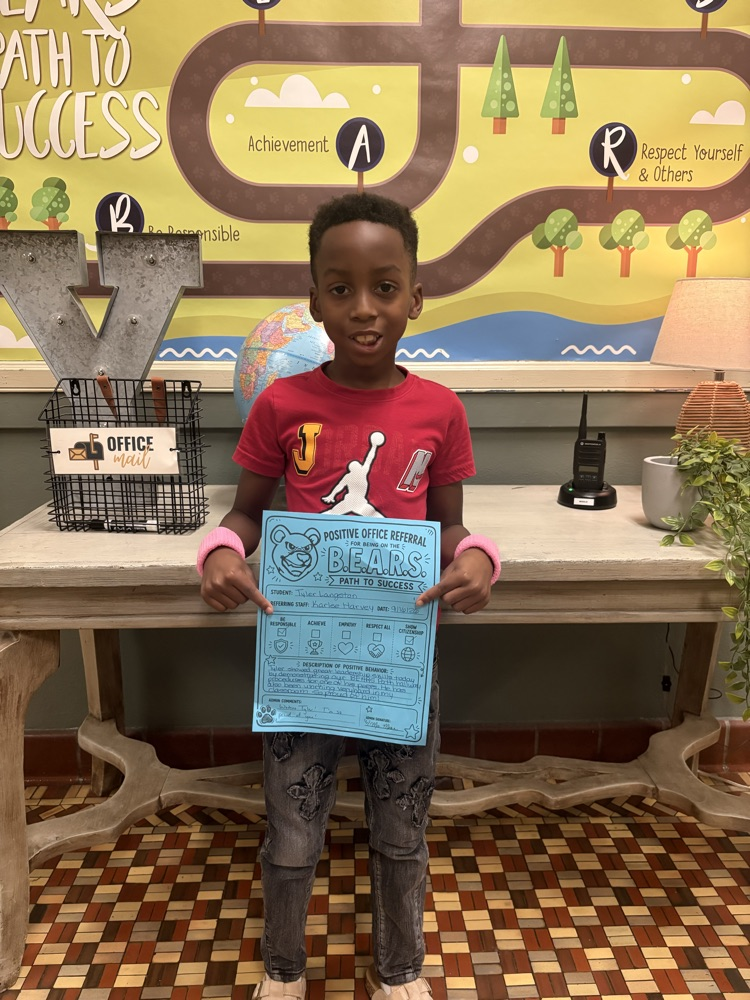 student holding positive office referral
